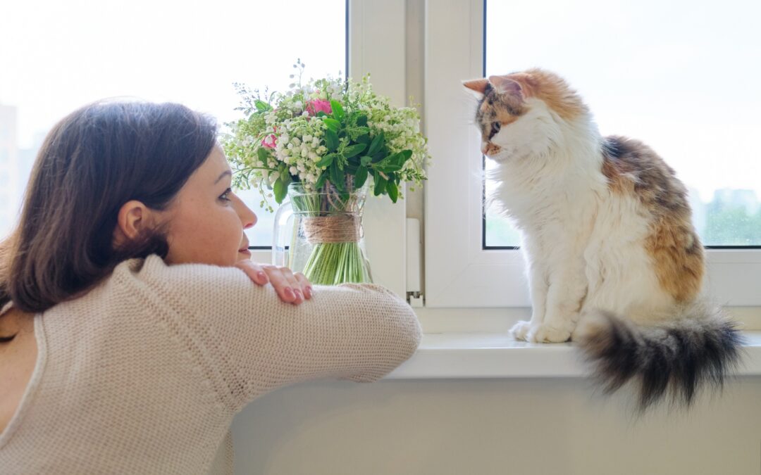 woman looking at her cat